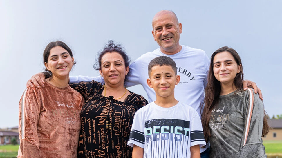 The Almohammed Family from Syria poses for a photo.