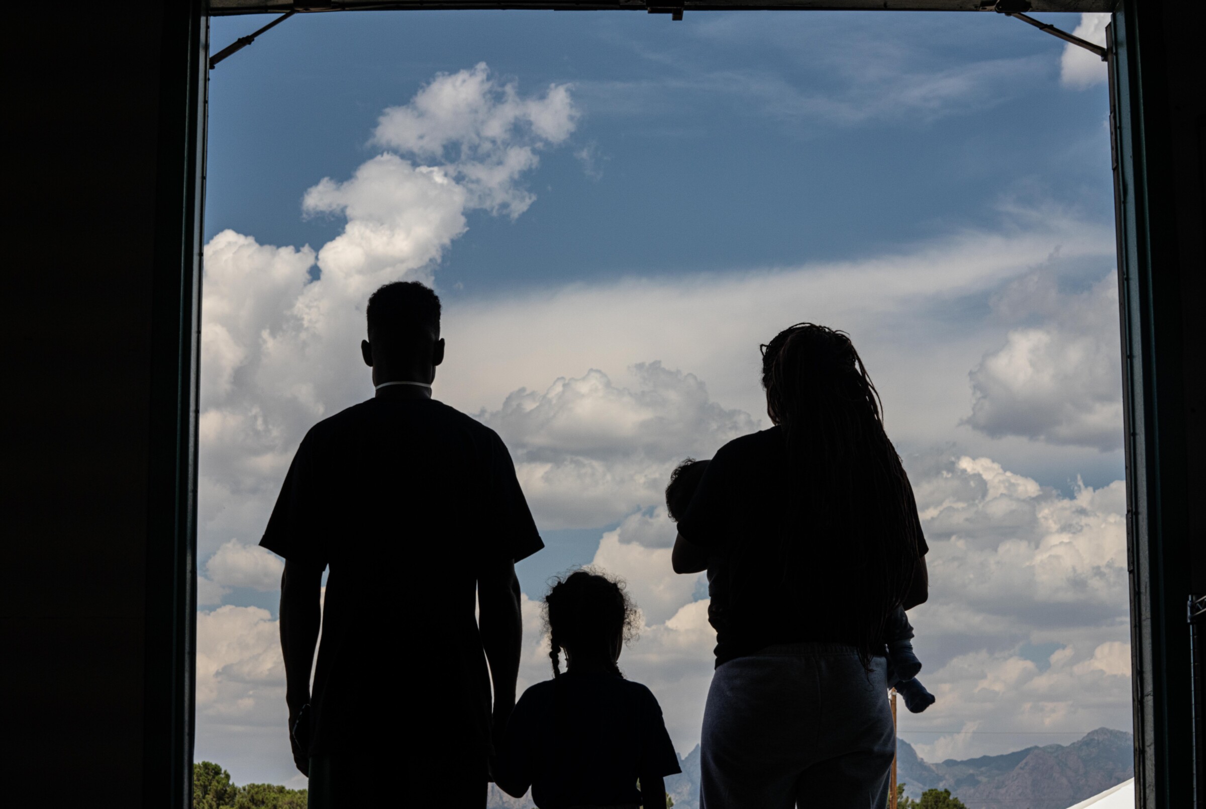 Silhouette of Venezuelan family in a doorway.