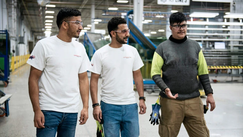 Ziarmal, Gul, and Abdul at their place of work in a glass manufacturing factory.